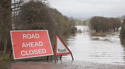 Flooded road with road closed sign