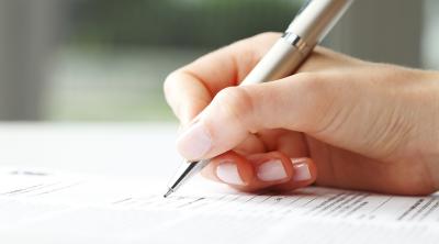 Image of hand signing the pledge 