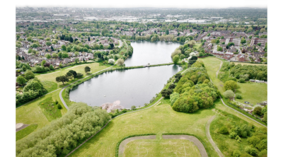Drone view of green fields outside an urban development