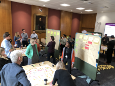 image showing people working on whiteboards in a conference room
