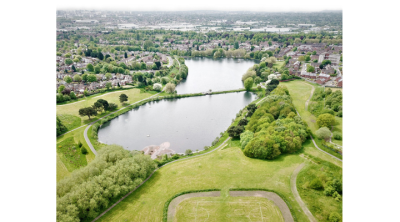 drone view of fields, lake and town